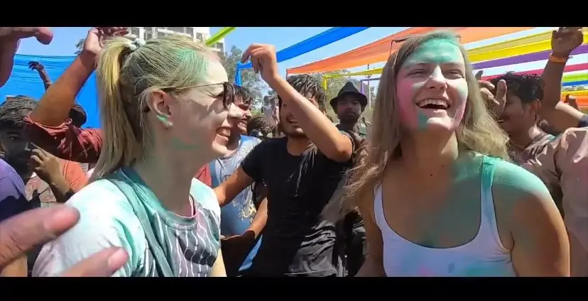 Two international guests dancing with the crowd at Go Pagal Holi in Ahmedabad